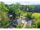 Aerial view of the property nestled among lush trees, showcasing the backyard and nearby baseball field at 849 Wood Nw St, Atlanta, GA 30318
