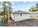 Exterior view of the newly painted house showing a tidy backyard and the side entrance at 849 Wood Nw St, Atlanta, GA 30318