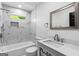 Bathroom features marble style tile in shower, a framed mirror and modern vanity at 849 Wood Nw St, Atlanta, GA 30318