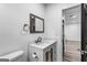 Bathroom featuring a vanity with a white countertop, a decorative mirror, and modern fixtures at 849 Wood Nw St, Atlanta, GA 30318