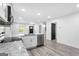 Open concept kitchen with stainless appliances, modern countertops and luxury vinyl plank floors at 849 Wood Nw St, Atlanta, GA 30318