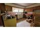 Functional kitchen layout with tile countertops, cabinetry, and awaiting renovation at 1198 Lynhurst Sw Dr, Atlanta, GA 30311