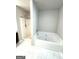 Bathroom featuring separate tub and shower with tile surround at 1605 Hydrangea Ln, Mcdonough, GA 30253