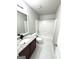 Bathroom with a granite vanity top, tile floors, and a shower-tub combo at 1605 Hydrangea Ln, Mcdonough, GA 30253