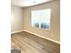 Bright bedroom featuring laminate flooring, window with blinds and neutral-colored walls at 1605 Hydrangea Ln, Mcdonough, GA 30253
