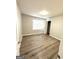 Bedroom featuring hardwood floors, neutral walls, closet, and natural light at 1605 Hydrangea Ln, Mcdonough, GA 30253