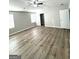 Spacious bedroom featuring modern ceiling fan and wood-look flooring at 1605 Hydrangea Ln, Mcdonough, GA 30253