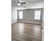 A bedroom offers wood-look floors and great natural light at 1605 Hydrangea Ln, Mcdonough, GA 30253