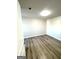 Bright bedroom featuring hardwood floors, neutral walls, and overhead lighting at 1605 Hydrangea Ln, Mcdonough, GA 30253