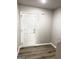 Entryway featuring durable wood-look flooring and a secure white door at 1605 Hydrangea Ln, Mcdonough, GA 30253