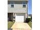 Exterior showcasing a garage door and a well-maintained lawn at 1605 Hydrangea Ln, Mcdonough, GA 30253