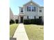 Inviting two-story townhome with manicured lawn and walkway leading to the front door at 1605 Hydrangea Ln, Mcdonough, GA 30253