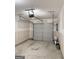Spacious garage with a gray door and an automatic opener at 1605 Hydrangea Ln, Mcdonough, GA 30253