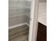 Pantry features laminate floor, white wire shelves and access to the kitchen at 1605 Hydrangea Ln, Mcdonough, GA 30253