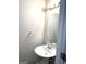A modern powder room features a pedestal sink and oval mirror at 1605 Hydrangea Ln, Mcdonough, GA 30253