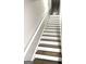 Well-lit staircase with hardwood treads and white risers at 1605 Hydrangea Ln, Mcdonough, GA 30253