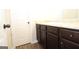 Bathroom featuring modern vanity, white countertop, dark wood cabinets and brushed nickel hardware at 305 Wheeler Creek Ln # 21, Mcdonough, GA 30252