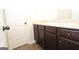 Bathroom featuring modern vanity, white countertop, dark wood cabinets and brushed nickel hardware at 305 Wheeler Creek Ln # 21, Mcdonough, GA 30252