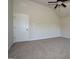 Bright bedroom with carpeted floors, ceiling fan, and a white paneled door at 305 Wheeler Creek Ln # 21, Mcdonough, GA 30252