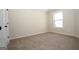 Bedroom with neutral carpet, a double hung window providing natural light, and a closet at 305 Wheeler Creek Ln # 21, Mcdonough, GA 30252