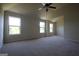 Spacious bedroom with ample light from the windows and a ceiling fan at 305 Wheeler Creek Ln # 21, Mcdonough, GA 30252
