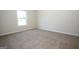 Bedroom with neutral carpet, a double hung window providing natural light, and a closet at 305 Wheeler Creek Ln # 21, Mcdonough, GA 30252