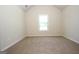 Bedroom with neutral carpet, a double hung window providing natural light, and a closet at 305 Wheeler Creek Ln # 21, Mcdonough, GA 30252