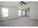 Bright, open bedroom with vaulted ceilings, large windows, and a ceiling fan at 305 Wheeler Creek Ln # 21, Mcdonough, GA 30252