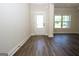 Bright foyer features attractive wood flooring, a white door, and natural light from a large window at 305 Wheeler Creek Ln # 21, Mcdonough, GA 30252