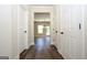 Hallway features attractive wood flooring and a view of the living room through a large doorway at 305 Wheeler Creek Ln # 21, Mcdonough, GA 30252