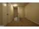 Hallway with neutral carpet, white doors and trim, and natural light from a window at 305 Wheeler Creek Ln # 21, Mcdonough, GA 30252