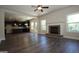 Open-concept living room with fireplace, ceiling fan, and lots of natural light at 305 Wheeler Creek Ln # 21, Mcdonough, GA 30252