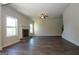 Open living room with a fireplace, windows, a ceiling fan, and attractive and durable wood flooring at 305 Wheeler Creek Ln # 21, Mcdonough, GA 30252