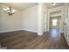 Inviting living room with neutral walls, stylish chandelier, and wood flooring perfect for relaxation at 305 Wheeler Creek Ln # 21, Mcdonough, GA 30252