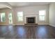 Bright living room with a fireplace, large windows, and hardwood flooring offers a cozy atmosphere at 305 Wheeler Creek Ln # 21, Mcdonough, GA 30252