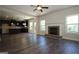 Spacious living room featuring a brick fireplace, ceiling fan, and large windows that enhance the natural light at 305 Wheeler Creek Ln # 21, Mcdonough, GA 30252