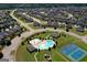 Stunning aerial view of neighborhood amenities including a pool, basketball court, playground and lush landscaping at 1597 Culpepper Ln, Mcdonough, GA 30253