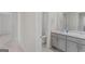 Hallway view of dual sinks and white cabinets in a well-lit modern bathroom at 1597 Culpepper Ln, Mcdonough, GA 30253