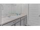 Bright bathroom with double sink vanity, gray cabinets and chrome hardware at 1597 Culpepper Ln, Mcdonough, GA 30253