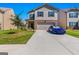 Charming two-story home with a brick-accented front and a well-manicured lawn with a blue car parked in the driveway at 1597 Culpepper Ln, Mcdonough, GA 30253