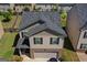 Aerial view of 2-story home features brick and siding exterior, manicured lawn, and a dark shingle roof at 1597 Culpepper Ln, Mcdonough, GA 30253