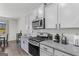 Modern kitchen with stainless steel appliances, granite countertops, and white cabinets at 1597 Culpepper Ln, Mcdonough, GA 30253