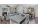 Kitchen island with granite countertops and stainless steel sink overlooking open living space at 1597 Culpepper Ln, Mcdonough, GA 30253