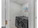 Laundry room with black front load washer and dryer and wire shelving at 1597 Culpepper Ln, Mcdonough, GA 30253