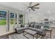 Spacious living room featuring a large sectional sofa, backyard views, and an open floor plan at 1597 Culpepper Ln, Mcdonough, GA 30253