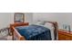Comfortable bedroom with a wooden dresser, nightstand and bed with a blue comforter at 1597 Culpepper Ln, Mcdonough, GA 30253