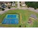 Aerial view of community tennis and basketball court, with playground at 1597 Culpepper Ln, Mcdonough, GA 30253