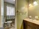 Functional bathroom featuring a vanity, toilet, and window for natural light in a compact space at 77 Crystal River Dr, Riverdale, GA 30274