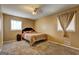 Comfortable bedroom with neutral tones, a plush bed, and natural light creates a serene retreat at 77 Crystal River Dr, Riverdale, GA 30274