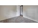 This bedroom features neutral carpeting and paint and an open door at 77 Crystal River Dr, Riverdale, GA 30274